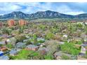 Panoramic aerial view featuring homes, lush trees, and mountain backdrop creating a picturesque neighborhood setting at 810 34Th St, Boulder, CO 80303
