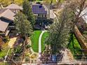Aerial view of a backyard with lush lawn, brick patio, and solar panels on the roof at 845 14Th St, Boulder, CO 80302