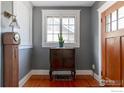 Inviting entryway with hardwood floors, a vintage cabinet, and a decorative window at 845 14Th St, Boulder, CO 80302