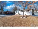 Charming, white, one-story home with well-maintained landscaping and beautiful mature tree in the front yard at 8861 Hastings Way, Westminster, CO 80031