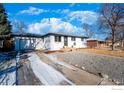 Charming, white, one-story home with well-maintained landscaping, driveway with snow at 8861 Hastings Way, Westminster, CO 80031