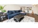 Comfortable living room with a plush blue sofa and a view to the kitchen at 1020 15Th St # 15E, Denver, CO 80202