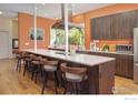 Spacious kitchen boasts a large island with seating, modern appliances, and a sleek design at 1025 Neon Forest Cir, Longmont, CO 80504