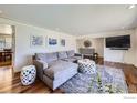 Comfortable living room with hardwood floors, a large sectional sofa, and stylish decor at 10340 W 34Th Ave, Wheat Ridge, CO 80033