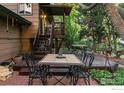 Inviting outdoor deck with patio furniture and access to backyard with mature trees and patio at 106 Starline Ave, Lafayette, CO 80026