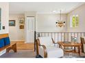 Cozy landing with a white armchair, hardwood floors, and a unique antler chandelier at 106 Starline Ave, Lafayette, CO 80026
