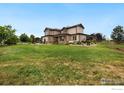 Expansive backyard with a well-manicured lawn and mature trees at 1105 Shelby Dr, Berthoud, CO 80513