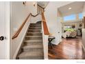 Inviting foyer with hardwood floors and staircase at 1105 Shelby Dr, Berthoud, CO 80513