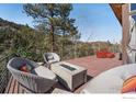 Inviting outdoor deck features a fire pit and comfortable seating, perfect for enjoying the surrounding nature at 1127 Valley Ln, Boulder, CO 80302