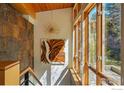 Bright entryway featuring natural light, stone accent wall, and modern light fixtures at 1127 Valley Ln, Boulder, CO 80302