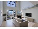 Bright living room with a fireplace, large windows, and a view of the mountains at 1200 Yarmouth Ave # 238, Boulder, CO 80304
