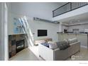 Open living area with a stone fireplace, modern furniture, and a view of the kitchen area at 1200 Yarmouth Ave # 238, Boulder, CO 80304