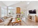 Cozy living room featuring a fireplace, hardwood floors, and a comfortable seating area at 1271 Hickory Dr, Erie, CO 80516
