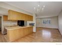 Efficient kitchen layout with adjacent dining area and hardwood flooring at 13580 Eliot Ct, Broomfield, CO 80020