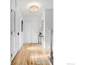 Bright hallway with light wood floors, white trim, and closet space at 1424 Kennedy Ct, Boulder, CO 80303