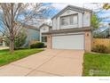 Charming two-story home with a well-maintained lawn, brick accents and attached two-car garage at 1842 Reliance Cir, Superior, CO 80027
