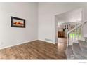 Bright living room featuring beautiful wood floors and an open floor plan with view to the kitchen at 1842 Reliance Cir, Superior, CO 80027