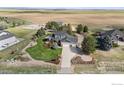 Stunning aerial view of a house with a landscaped yard, detached garage, and picturesque surroundings at 18553 Wagon Trl, Mead, CO 80542