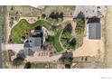 Expansive aerial view showing the house, detached garage, and meticulously landscaped yard at 18553 Wagon Trl, Mead, CO 80542