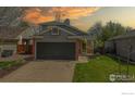Charming home featuring a two-car garage, a well-manicured lawn, and tasteful landscaping around the front walkway at 2330 Redwood Ave, Lafayette, CO 80026