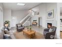 Bright, open living area featuring a fireplace, vaulted ceiling, and large windows for ample natural light at 2330 Redwood Ave, Lafayette, CO 80026