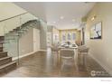 Dining room with modern table, glass railed stairway, and hardwood floors at 2624 S Race St, Denver, CO 80210