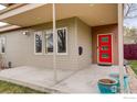 Inviting front porch features a red door, modern planters, and neutral-toned siding at 2624 S Race St, Denver, CO 80210
