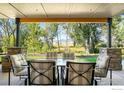 Relaxing covered patio with outdoor seating offers scenic views of the lush backyard and mountains at 313 S 3Rd Ave, Superior, CO 80027