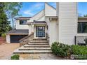 Inviting front entrance with stone steps, a black front door, and a well-maintained exterior at 3890 Norwood Ct, Boulder, CO 80304