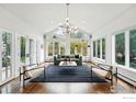 Bright living room with large windows, hardwood floors, and modern lighting fixture at 3890 Norwood Ct, Boulder, CO 80304
