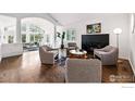 Open-concept living room with fireplace, hardwood floors, modern decor and natural light at 3890 Norwood Ct, Boulder, CO 80304