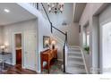 Grand foyer with a staircase, chandelier, and stylish console table, creating an elegant entrance at 4203 Rabbit Mountain Rd, Broomfield, CO 80020