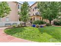 Beautiful landscaped grounds surrounding building with walkway benches, plantings and trees at 4500 Baseline Rd # 3302, Boulder, CO 80303