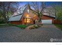 Charming exterior shot of a chalet-style home, highlighting its distinctive architecture and inviting ambiance at twilight at 4731 Jay Rd, Boulder, CO 80301