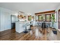 Open concept kitchen with modern island, stainless steel refrigerator, and adjacent dining area at 4731 Jay Rd, Boulder, CO 80301