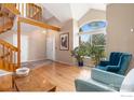 Bright living room boasts hardwood floors, large windows, and vaulted ceilings with an open stairway at 5587 Glendale Gulch Cir, Boulder, CO 80301