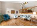 Cozy living room features hardwood floors, comfortable seating, and a view of the upper level at 5587 Glendale Gulch Cir, Boulder, CO 80301