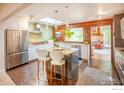 Bright, modern kitchen with stainless steel appliances, wood accents, and a spacious island with seating at 560 Iris Ave, Boulder, CO 80304