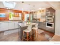 Well-lit modern kitchen featuring sleek cabinetry, a kitchen island, and stainless steel appliances at 560 Iris Ave, Boulder, CO 80304