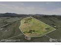 Beautiful aerial view highlighting the property's expansive land, lush greenery, and mountain views at 6319 Sedona Hills Dr, Berthoud, CO 80513