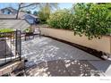 Serene back patio with flagstone, offering a private outdoor space surrounded by manicured greenery and a privacy fence at 650 Ridgeview Dr, Louisville, CO 80027