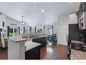 Open kitchen featuring granite countertops, stainless steel appliances, and adjacent dining area at 725 Canyonlands St, Berthoud, CO 80513
