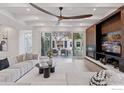 Bright and airy living room featuring a modern ceiling fan, fireplace, and sliding glass doors to the outdoor patio at 7323 Old Post Rd, Boulder, CO 80301