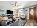 Inviting living room with cozy seating, a decorative fireplace, and large windows offering ample natural light at 7960 Estes Ct, Arvada, CO 80005