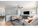 Bright living room with comfortable seating, modern decor, and a view into the adjacent dining area at 7960 Estes Ct, Arvada, CO 80005