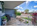 Cozy front porch showcases updated railing and gray brick exterior of this well-maintained home at 8200 Delaware St, Denver, CO 80221