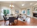 Bright living room featuring hardwood floors, fireplace, and an open concept design with lots of natural light at 8255 E 150Th Pl, Thornton, CO 80602