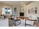 Cozy living area with a fireplace, comfortable seating, and tasteful decor, perfect for relaxation and entertaining at 8255 E 150Th Pl, Thornton, CO 80602