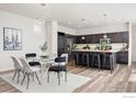 Dining area with modern furnishings and a view of the gourmet kitchen at 10022 Reunion Pkwy, Commerce City, CO 80022