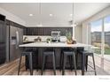 Kitchen features a large island with bar seating and stainless steel appliances at 10022 Reunion Pkwy, Commerce City, CO 80022